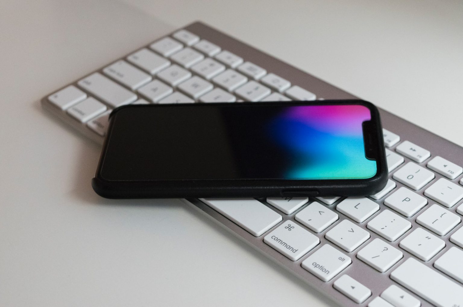 Why It Pays To Have A Semi-Smartphone Android smartphone on Apple magic keyboard