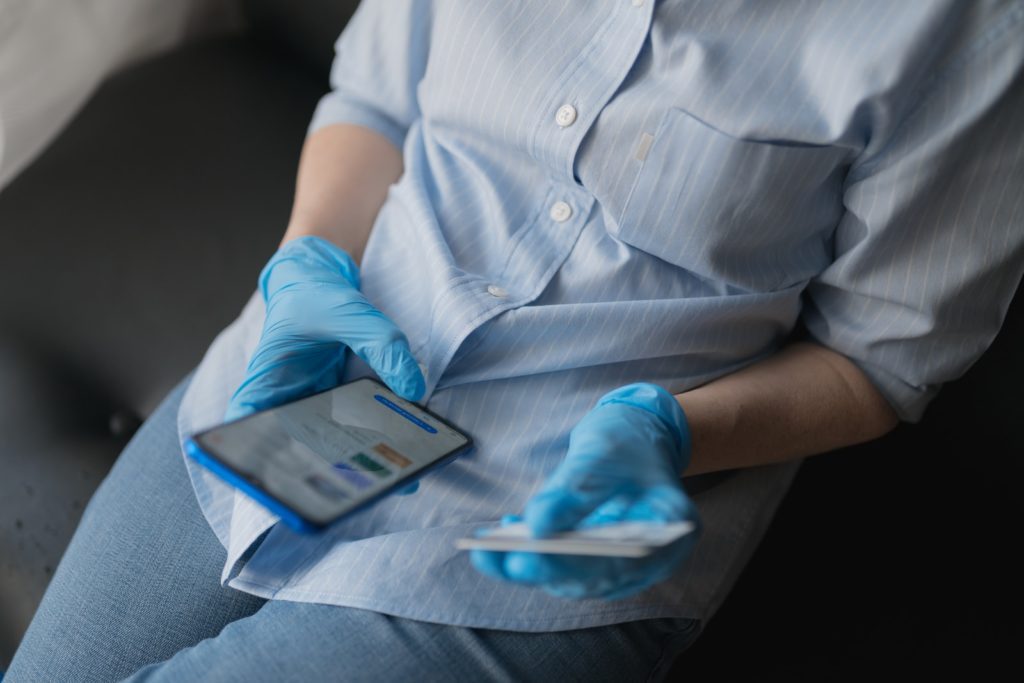 Optimizing Your Medical Online Marketing person in blue button up shirt and blue denim jeans sitting on gray couch