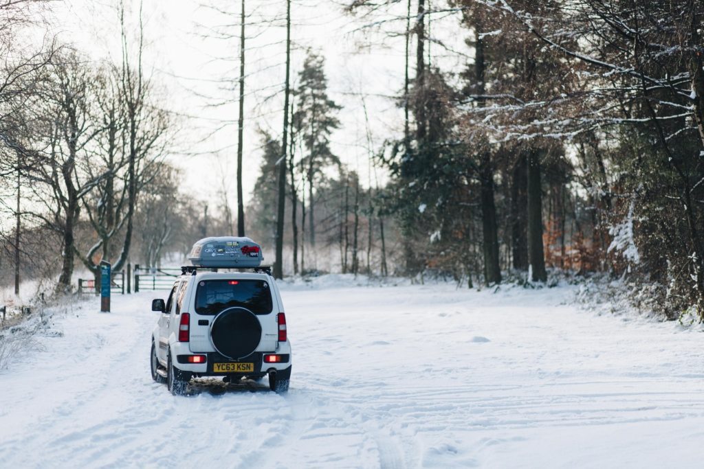 white compact van at snow path