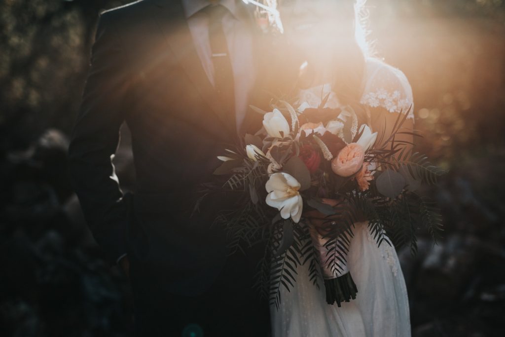 Have You Ever Thought You Can Save Bundles On Flowers? groom beside bride holding bouquet flowers