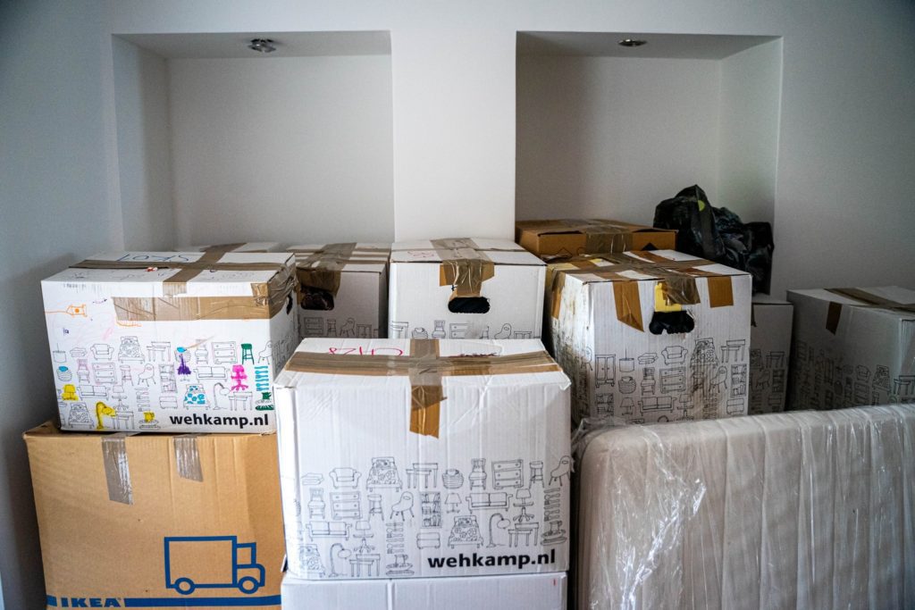 Take The Stress Out Of Your Big Move brown cardboard boxes on brown wooden table