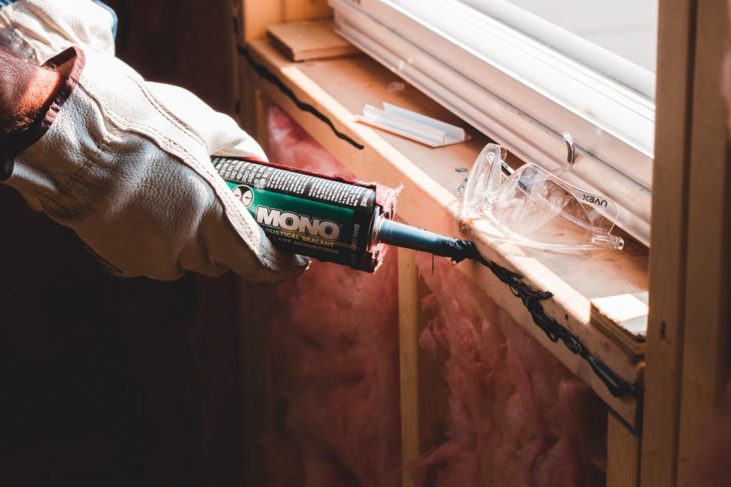 5 Of The Best Ways To Safe On Home Improvement Costs person holding green and white pack